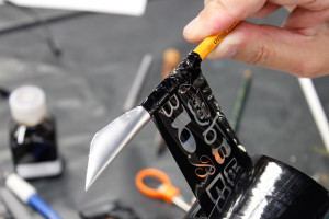 Hand-made folded pen, tape being attached